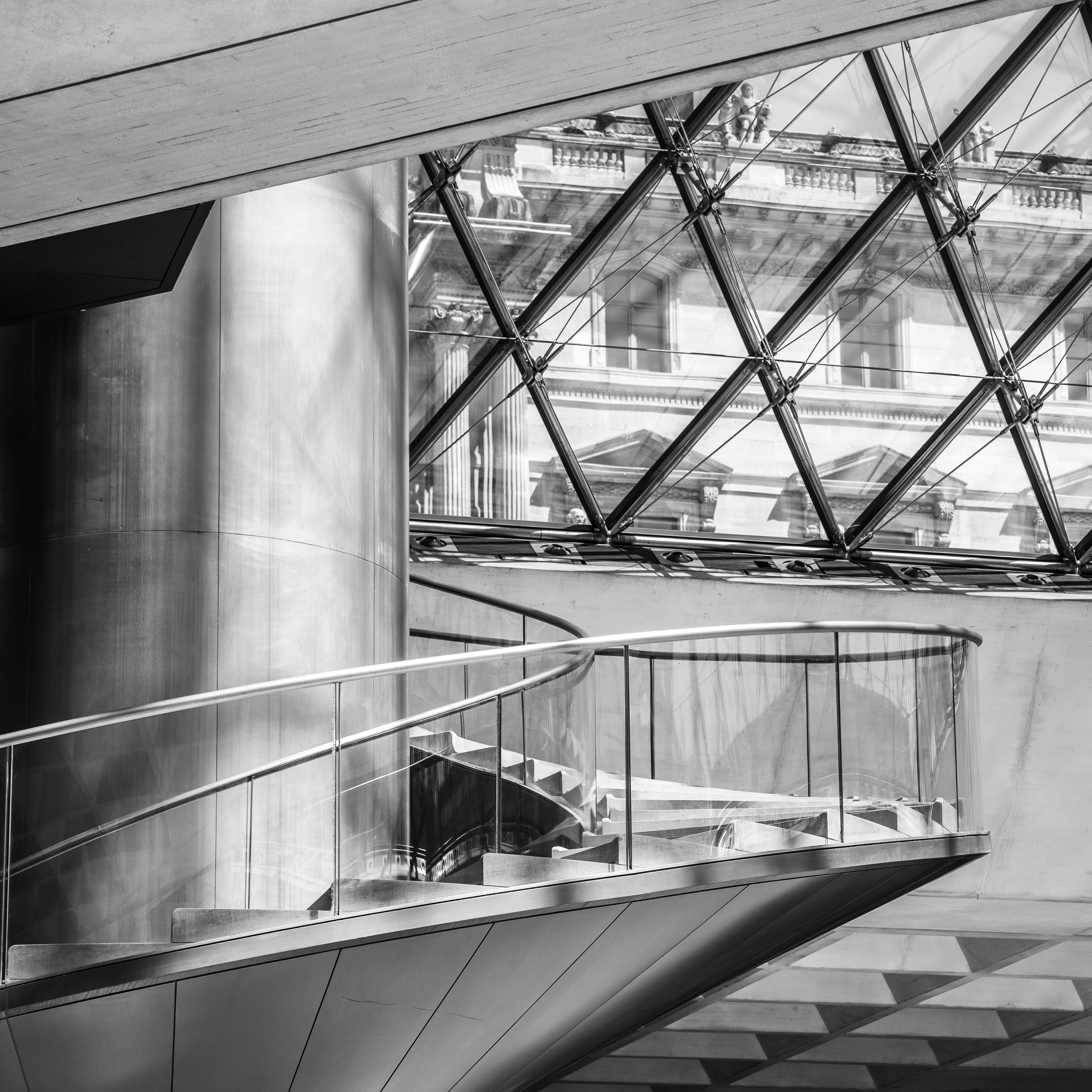 Modern architectural interior with a staircase and glass ceiling